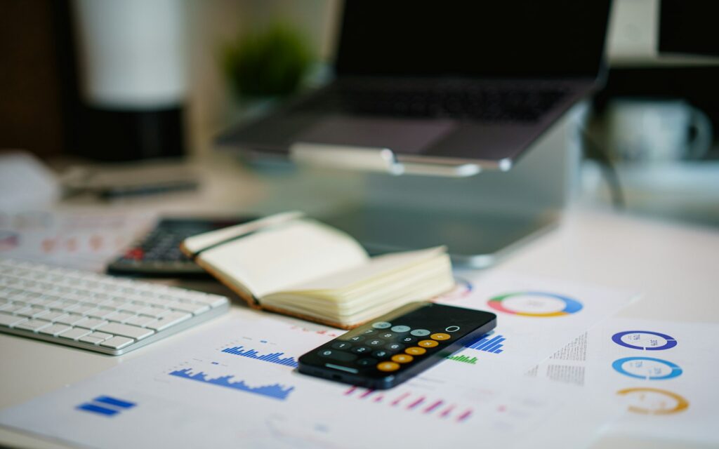 office desk with smartphone and financial charts