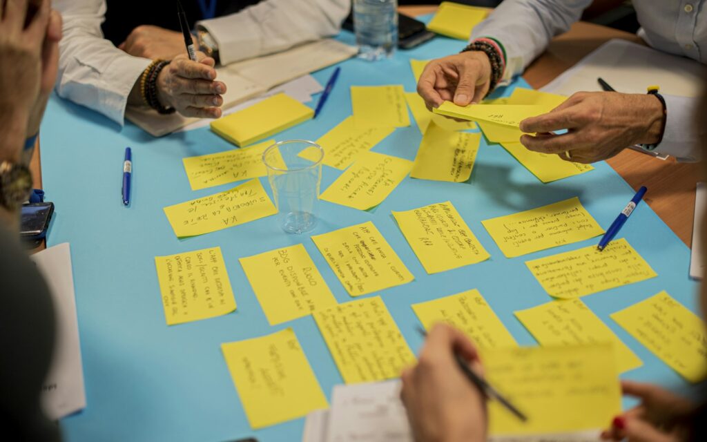 person holding yellow sticky notes